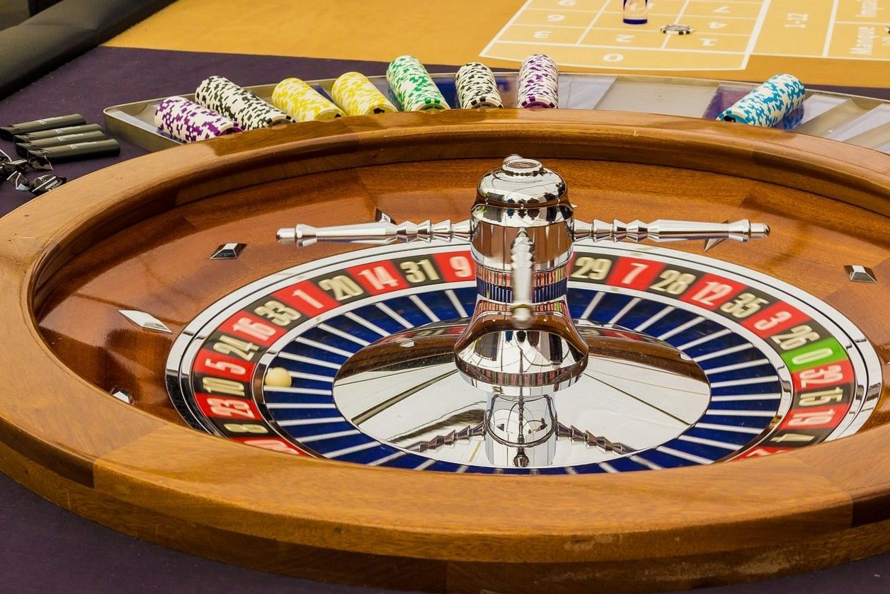 A close-up of playing cards and chips on a premium felt table